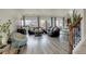 Spacious living room with hardwood floors, modern furniture, and large windows providing natural light at 4971 Ceylon Way, Denver, CO 80249