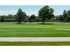 Scenic golf course with lush green fairways and mature trees in a beautiful community at 8730 Chase Dr # 141, Arvada, CO 80003