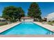 Inviting community pool surrounded by lounge chairs and a fenced area at 8730 Chase Dr # 141, Arvada, CO 80003