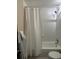 This bathroom features shower over tub, sink, toilet and tiled walls and floor at 1203 Washington Ave # 201, Golden, CO 80401