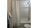 This bathroom features shower over tub, sink, toilet and tiled walls and floor at 1203 Washington Ave # 201, Golden, CO 80401