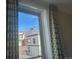 Window view featuring a beautiful mountain under a clear blue sky, framed by stylish patterned curtains at 1203 Washington Ave # 201, Golden, CO 80401