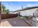 Deck with string lights and a view of a fenced backyard with raised garden beds at 63 Harrison St, Denver, CO 80206