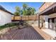 Spacious backyard deck with built-in planters and steps leading to fenced yard at 63 Harrison St, Denver, CO 80206