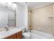 Clean bathroom with tub and wood vanity at 63 Harrison St, Denver, CO 80206