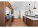 Modern kitchen features stainless steel appliances and wood cabinetry at 63 Harrison St, Denver, CO 80206