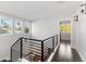 Modern upper landing with metal railing and hardwood floors at 63 Harrison St, Denver, CO 80206