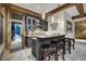 Charming bar area with custom cabinetry, stone countertop, and rustic wooden bar stools at 422 Timber Trail Rd, Breckenridge, CO 80424
