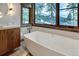 Well-lit bathroom with a large soaking tub and scenic views at 422 Timber Trail Rd, Breckenridge, CO 80424