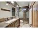 Modern bathroom boasts unique license plate wall design, glass shower, and wooden vanity with vessel sink at 422 Timber Trail Rd, Breckenridge, CO 80424