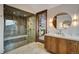 Modern bathroom featuring a glass-enclosed shower and stylish vanity with wood cabinets at 422 Timber Trail Rd, Breckenridge, CO 80424