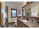 Rustic bathroom features a granite countertop, wooden mirror frame, tiled backsplash and a window view at 422 Timber Trail Rd, Breckenridge, CO 80424