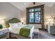 Bright bedroom with large window, elegant furnishings, and views of the surrounding forest at 422 Timber Trail Rd, Breckenridge, CO 80424