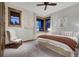 Cozy bedroom with a large bed, fur chair, neutral walls, artwork, and views of the outdoors at 422 Timber Trail Rd, Breckenridge, CO 80424