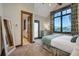 Comfortable bedroom with ensuite bathroom, scenic views from large window, and cozy decor at 422 Timber Trail Rd, Breckenridge, CO 80424