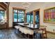 Elegant dining room features a large wooden table with faux fur benches and mountain views at 422 Timber Trail Rd, Breckenridge, CO 80424