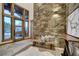 Inviting entryway with stone accent wall, wood bench seating, and large windows showcasing the outdoors at 422 Timber Trail Rd, Breckenridge, CO 80424