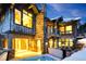Exterior view of a luxury home featuring a patio, hot tub, outdoor seating, and views of trees at 422 Timber Trail Rd, Breckenridge, CO 80424