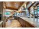 Spacious rustic kitchen with wood beams, stone fireplace and granite counters at 422 Timber Trail Rd, Breckenridge, CO 80424