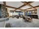 Spacious living room featuring exposed beams, stone fireplace, and large windows overlooking a snowy landscape at 422 Timber Trail Rd, Breckenridge, CO 80424