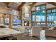 Inviting living room featuring a stone fireplace and expansive windows showcasing scenic views at 422 Timber Trail Rd, Breckenridge, CO 80424