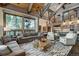 Spacious living room featuring vaulted ceilings, exposed beams, and scenic mountain views at 422 Timber Trail Rd, Breckenridge, CO 80424