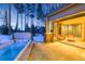 Outdoor patio features a hot tub, stone patio, and view of the trees with retractable doors to the interior at 422 Timber Trail Rd, Breckenridge, CO 80424