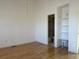 Unfurnished bedroom featuring wood floors and a glimpse into the ensuite bathroom at 1339 Sumner St # B, Longmont, CO 80501