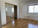 Bright bedroom with hardwood floors, mirrored closet, and natural light from the windows at 1339 Sumner St # B, Longmont, CO 80501
