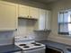 Clean kitchen with white cabinets and standard white electric range at 1339 Sumner St # B, Longmont, CO 80501