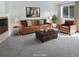 Cozy living room with leather sofa and chair, coffee table and soft natural lighting from large windows at 1339 Sumner St # B, Longmont, CO 80501