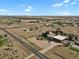 Aerial view of the property featuring a custom home, airstrip, and surrounding landscape at 4719 Beverly Ln, Erie, CO 80516