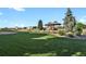 Expansive backyard with manicured lawn and gazebo surrounded by mature trees at 4719 Beverly Ln, Erie, CO 80516