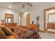 Spacious bedroom features wood furnishings, warm colors, and ensuite bathroom access at 4719 Beverly Ln, Erie, CO 80516