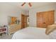 Cozy bedroom with natural wood accents, double door closet, and decorative dresser at 4719 Beverly Ln, Erie, CO 80516
