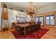 Elegant dining room with a wooden table, antler chandelier, and decorative accents at 4719 Beverly Ln, Erie, CO 80516
