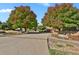 Long driveway leading to a Southwest-style home, flanked by mature trees at 4719 Beverly Ln, Erie, CO 80516