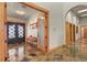 Elegant foyer with slate tile flooring, wood trim and double doors at 4719 Beverly Ln, Erie, CO 80516
