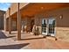 Covered front entrance featuring double doors, stone accents, and autumn decorations at 4719 Beverly Ln, Erie, CO 80516