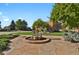 Beautifully landscaped front yard featuring stone patio and fountain with mature trees at 4719 Beverly Ln, Erie, CO 80516