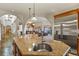 Open kitchen with a large island, stainless steel refrigerator, and views of the living areas at 4719 Beverly Ln, Erie, CO 80516