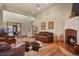 Inviting living room with hardwood floors, fireplace, and leather furniture at 4719 Beverly Ln, Erie, CO 80516