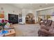 Cozy living room features a fireplace, plush seating, and an open floor plan to the kitchen at 4719 Beverly Ln, Erie, CO 80516