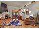 Cozy living room with hardwood floors, fireplace, and leather furniture at 4719 Beverly Ln, Erie, CO 80516