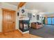 Cozy living room featuring a stone fireplace, wooden accents, and comfortable leather seating at 4719 Beverly Ln, Erie, CO 80516