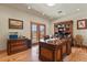 Home office with custom wood desk, built-in bookshelves, and an outdoor view at 4719 Beverly Ln, Erie, CO 80516