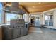 Covered outdoor kitchen with stainless steel Viking grill, bar, and view to the interior living space at 4719 Beverly Ln, Erie, CO 80516
