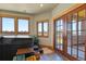 Enclosed hot tub room with tile flooring, wood trim, and glass doors to the outside at 4719 Beverly Ln, Erie, CO 80516