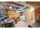 Unique basement with drop ceiling, laundry area, and custom shelving at 6050 Marshall Ct, Arvada, CO 80003