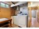 Basement laundry area features a washer and dryer and access to additional storage space at 6050 Marshall Ct, Arvada, CO 80003